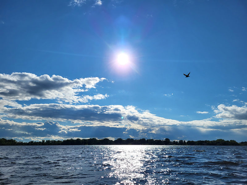 A picture of a lake during the afternoon.