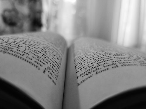 Black and white photo of book pages up close.