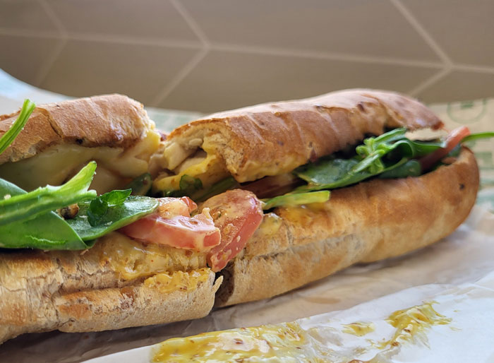 Close-up of a sandwich resting on a table.