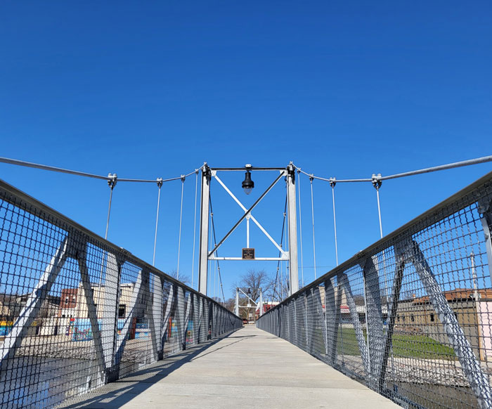 A picture of a bridge walkway with a blue background.